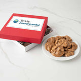 Red box with custom logo next to a plate of pralines on a white surface
