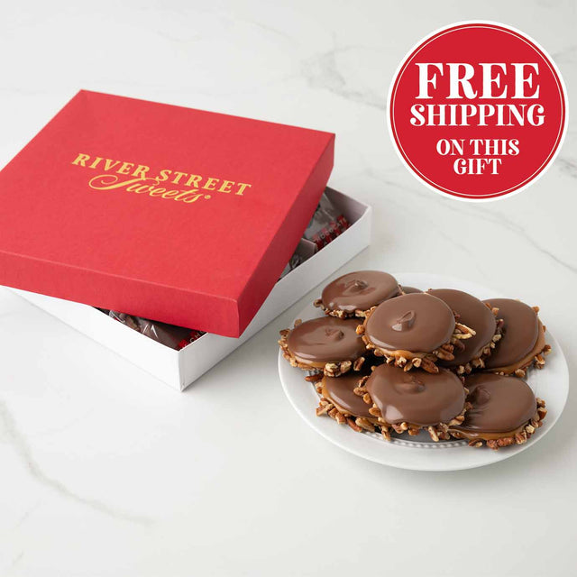 Red gift box with 'River Street Sweets' branding, open to reveal chocolates, on a white surface with a 'Free Shipping On This Gift' badge.